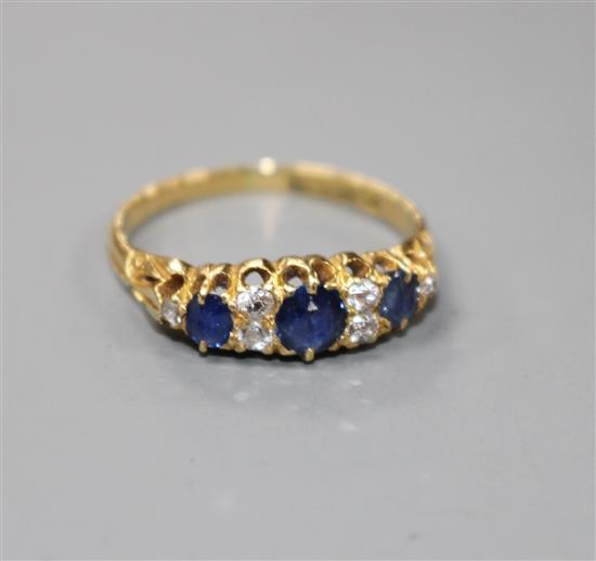 A George V 18ct gold, three stone sapphire and six stone diamond set half hoop ring,
